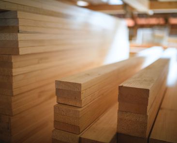 Piles of wood material for carpentry and construction in a carpenters warehouse.